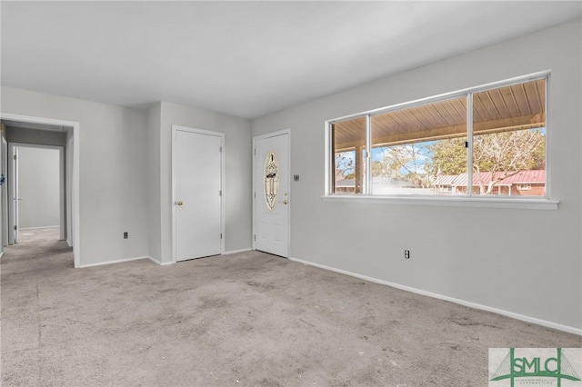 empty room with carpet floors and baseboards