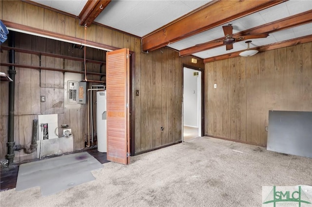 carpeted spare room featuring water heater, wood walls, beam ceiling, and electric panel