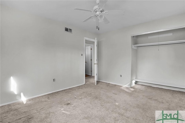 unfurnished bedroom with carpet, a closet, visible vents, attic access, and baseboards