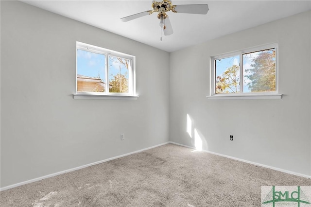 unfurnished room with carpet, a ceiling fan, and baseboards