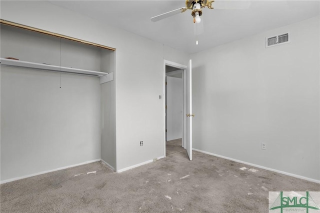 unfurnished bedroom featuring carpet floors, a closet, visible vents, attic access, and baseboards