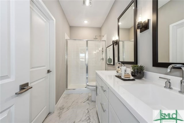 bathroom featuring marble finish floor, a sink, a shower stall, and toilet