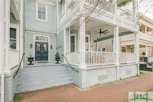 doorway to property with covered porch and ceiling fan