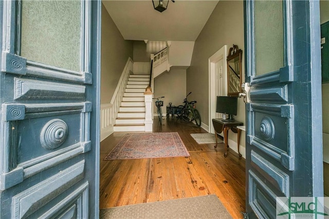 entryway featuring stairway and wood finished floors