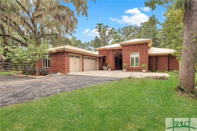 ranch-style home with a garage, driveway, fence, a front lawn, and brick siding