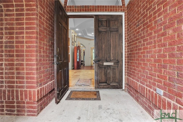 doorway to property with brick siding