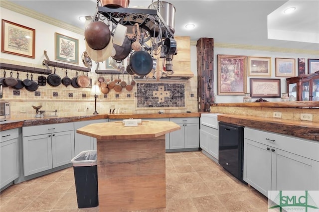 kitchen featuring ornamental molding, wooden counters, and backsplash