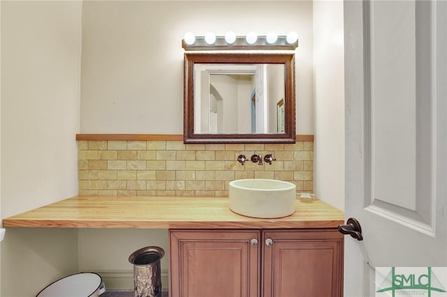 bathroom with tasteful backsplash and vanity