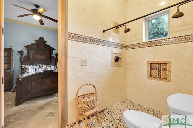 full bath with toilet, ceiling fan, and a tile shower