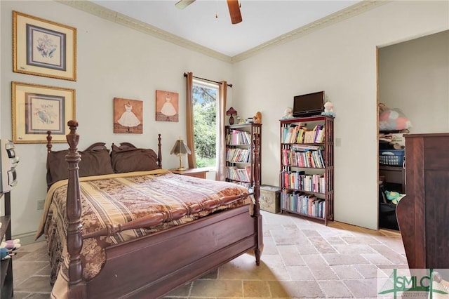 bedroom with ceiling fan, ornamental molding, and stone tile flooring