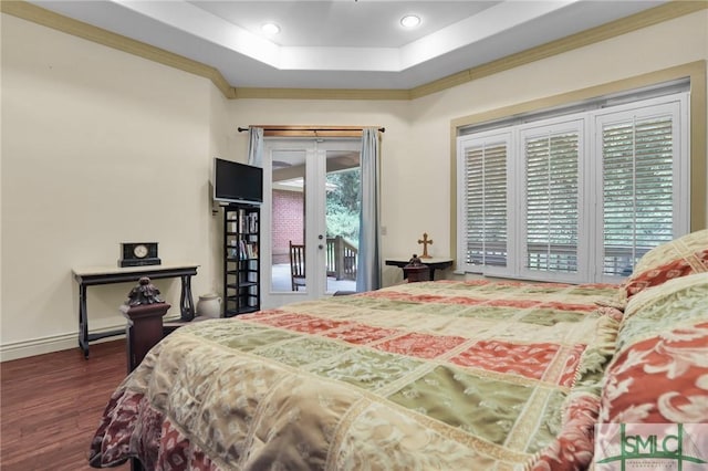 bedroom featuring baseboards, wood finished floors, access to exterior, a tray ceiling, and french doors