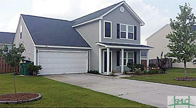 traditional-style house with a front yard, concrete driveway, covered porch, and fence