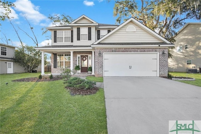 traditional-style home with a garage, a front yard, brick siding, and driveway