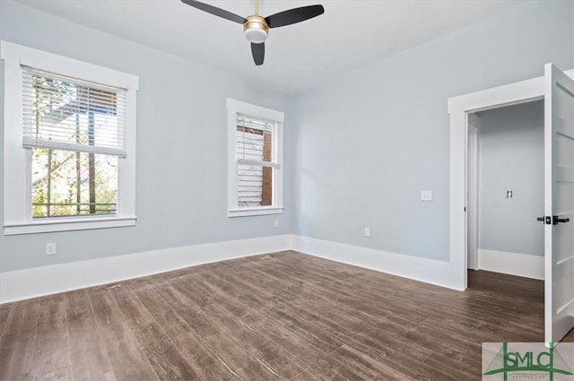 unfurnished bedroom with dark wood-style floors, baseboards, and a ceiling fan