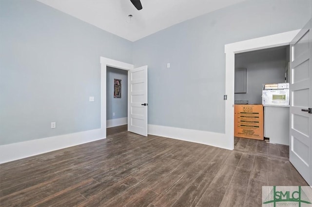 unfurnished bedroom with dark wood-type flooring, baseboards, and a ceiling fan