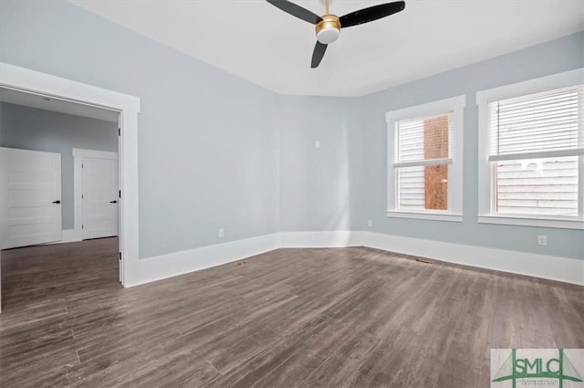 spare room featuring a ceiling fan, baseboards, and wood finished floors