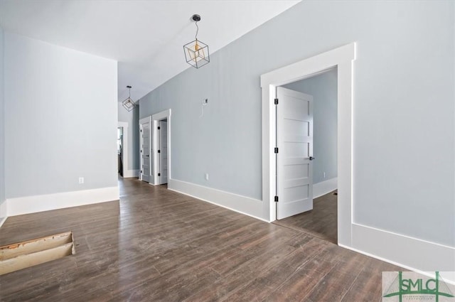 interior space featuring baseboards and wood finished floors