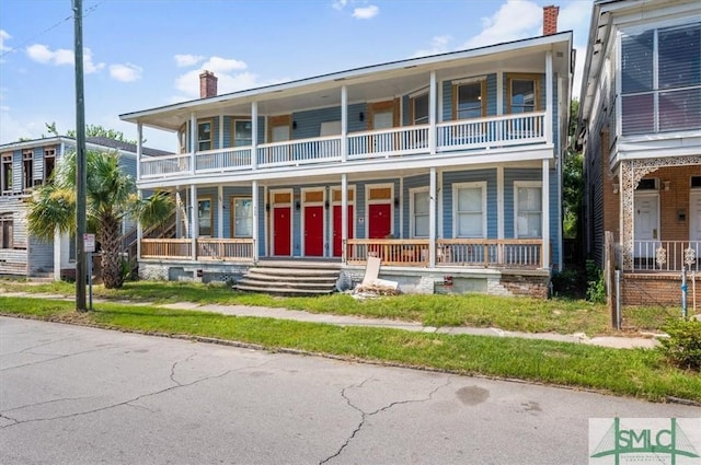 view of front of home with covered porch and a chimney