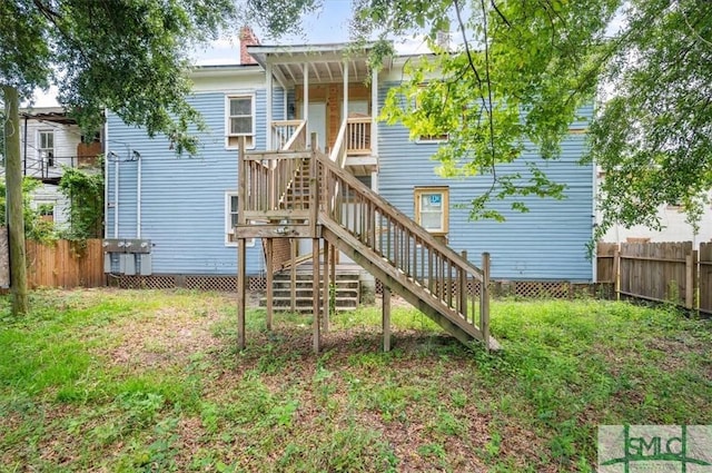 view of playground featuring fence, stairway, and a yard