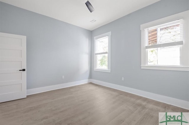 unfurnished room featuring wood finished floors, a ceiling fan, and baseboards