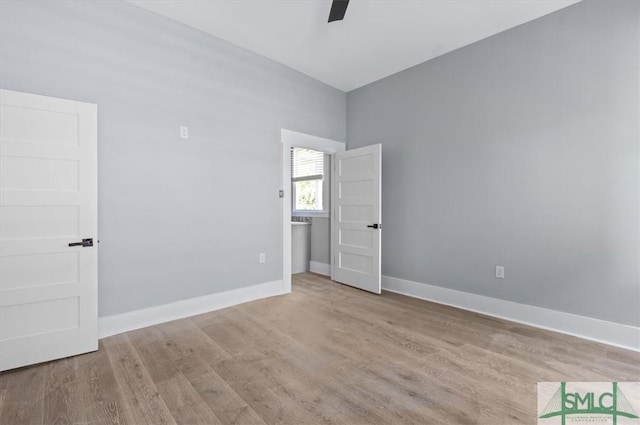 empty room featuring ceiling fan, wood finished floors, and baseboards