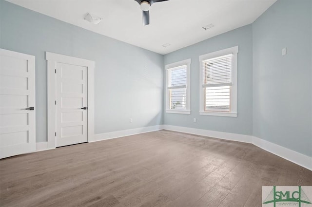 unfurnished room with ceiling fan, baseboards, and wood finished floors