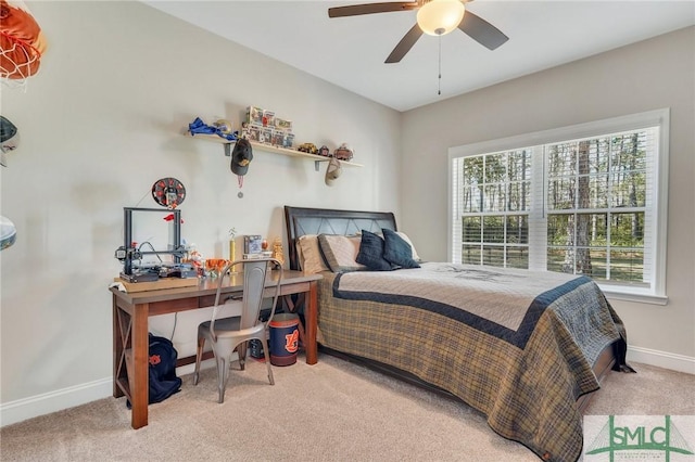 carpeted bedroom featuring a ceiling fan and baseboards