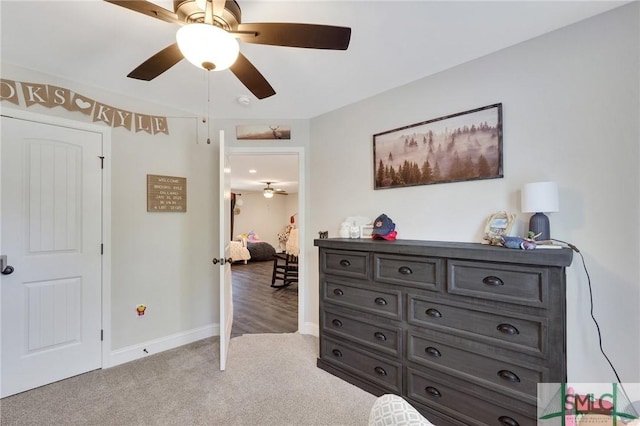 bedroom featuring carpet floors, a ceiling fan, and baseboards