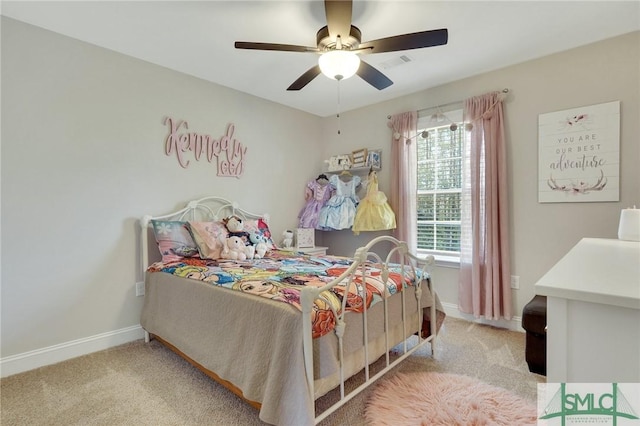 carpeted bedroom featuring ceiling fan, visible vents, and baseboards