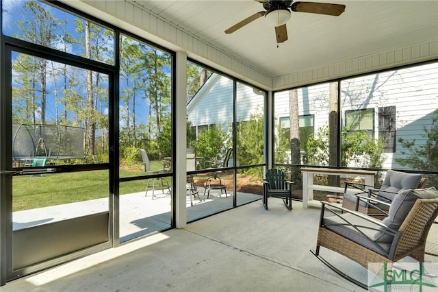 unfurnished sunroom featuring a ceiling fan