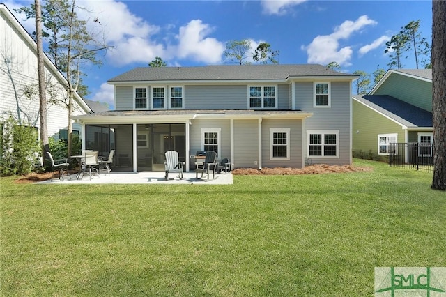 rear view of property with a sunroom, a patio area, a lawn, and fence