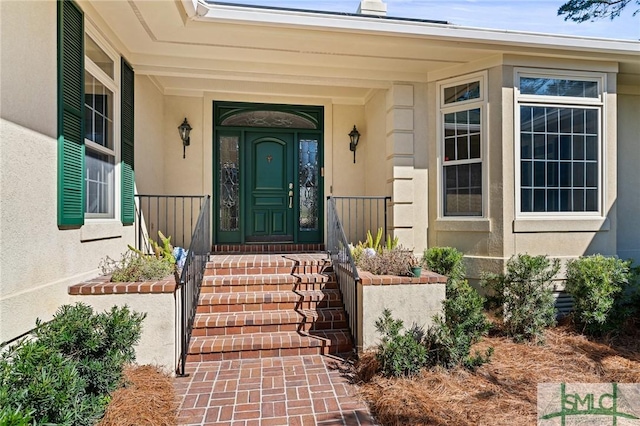 doorway to property featuring stucco siding