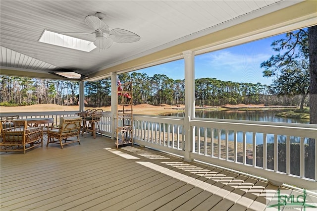 deck with a water view and a ceiling fan