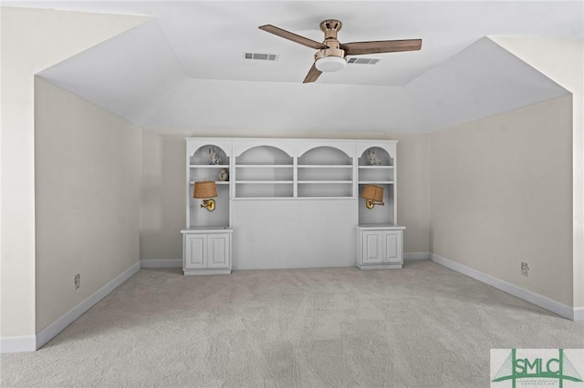 unfurnished room with carpet floors, visible vents, ceiling fan, and baseboards