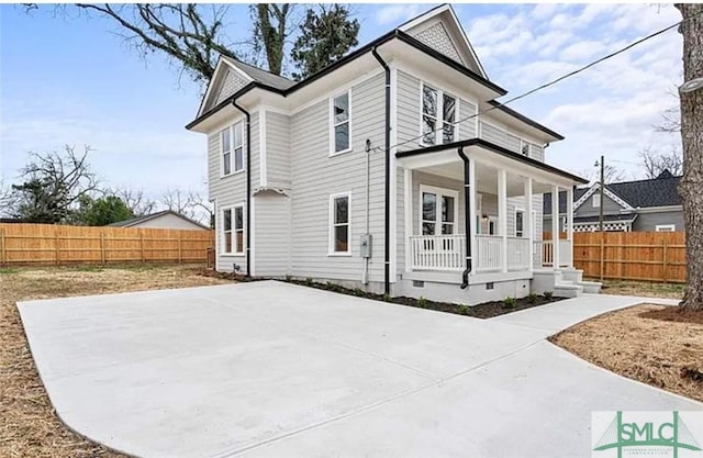 view of front of property with covered porch, fence, and crawl space