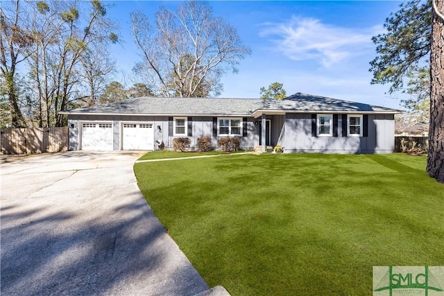 ranch-style home featuring a front yard, fence, driveway, and an attached garage