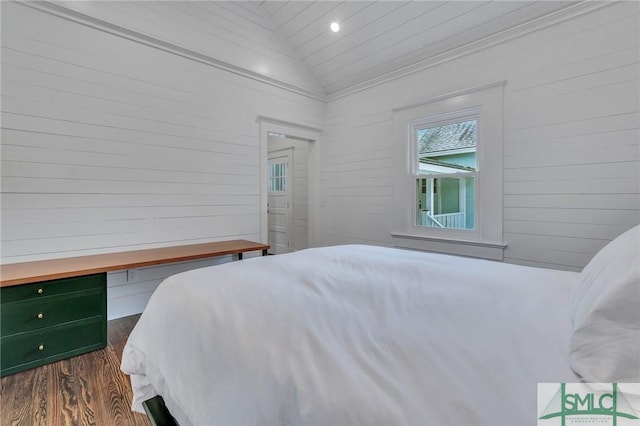 bedroom featuring dark wood finished floors and vaulted ceiling