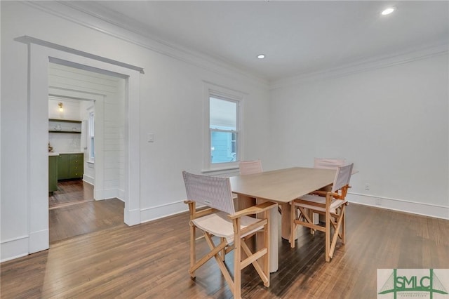 dining area featuring baseboards, dark wood-style flooring, crown molding, and recessed lighting