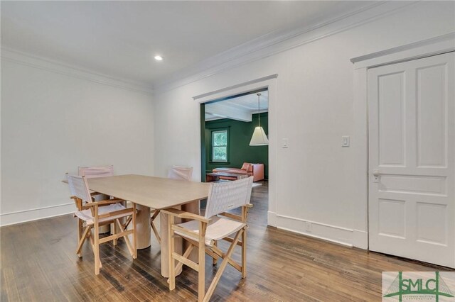 dining space featuring crown molding, baseboards, wood finished floors, and recessed lighting