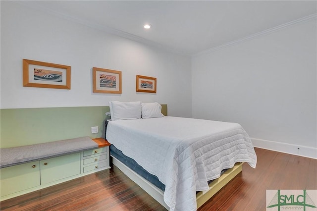 bedroom with baseboards, ornamental molding, and dark wood-style flooring