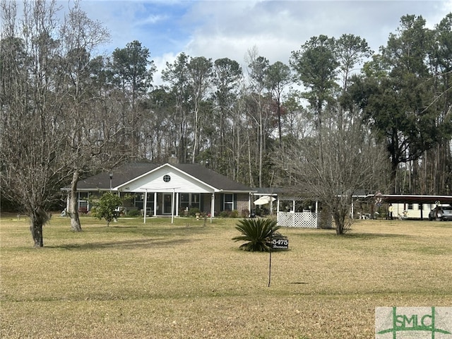 view of property's community featuring a carport and a lawn