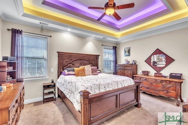 bedroom featuring a tray ceiling, light carpet, crown molding, and visible vents