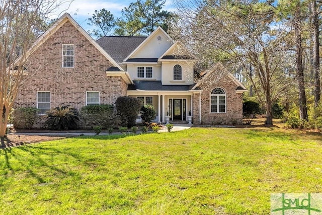 traditional home with brick siding, a front lawn, and stucco siding