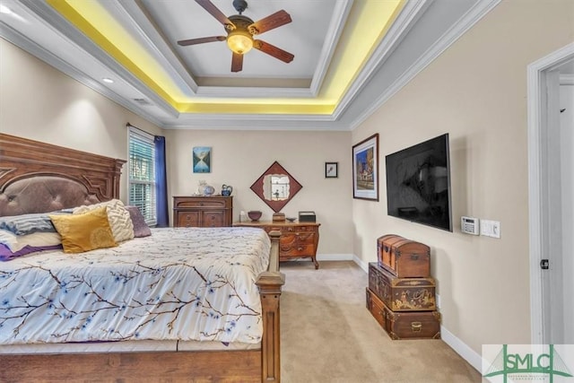 carpeted bedroom with ornamental molding, a tray ceiling, a ceiling fan, and baseboards