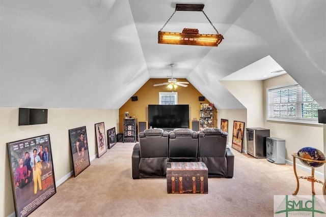 cinema with carpet floors, baseboards, and vaulted ceiling