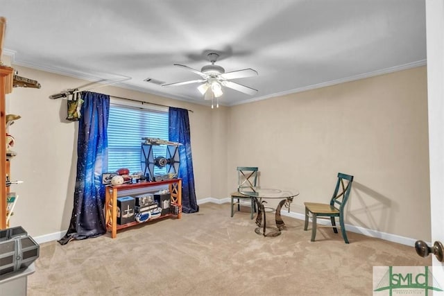 sitting room with carpet, visible vents, baseboards, and ornamental molding