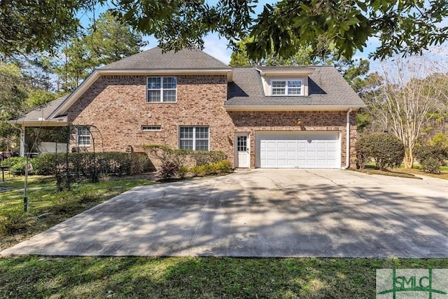 traditional home with a garage, driveway, and brick siding