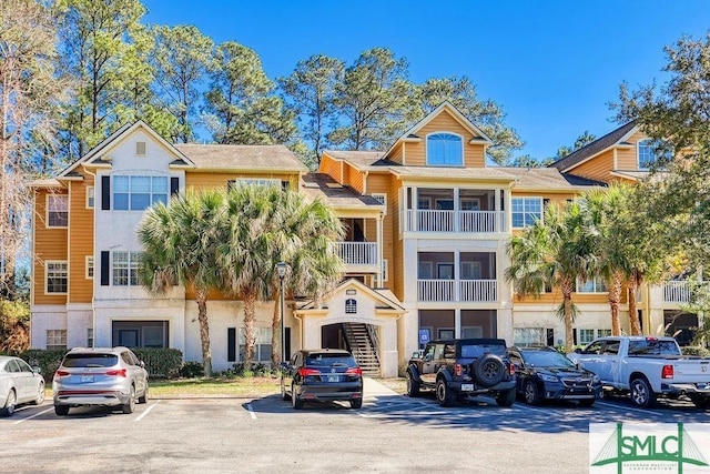 view of property featuring uncovered parking