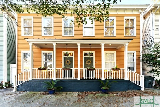 townhome / multi-family property featuring a porch