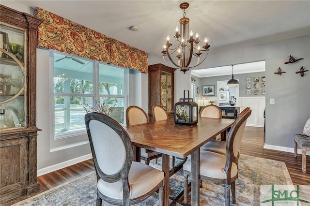 dining space with baseboards and wood finished floors